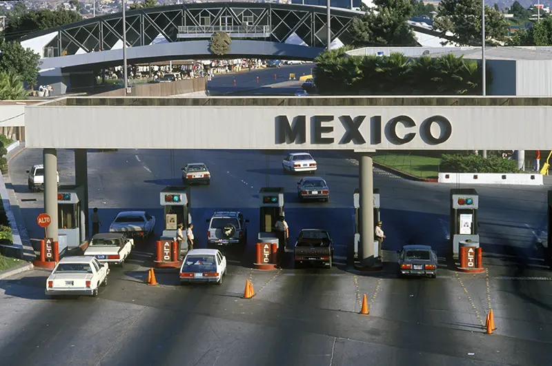 A view of cars driving through the border crossing.